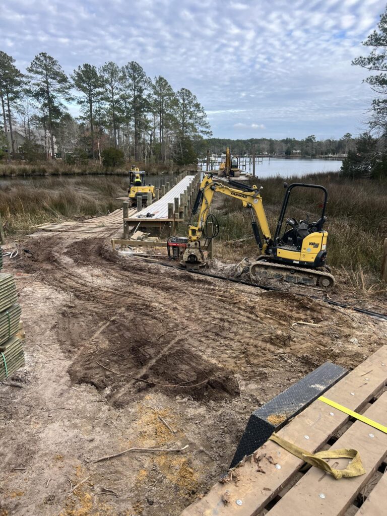 construction vehicles working to clear land in preparation for a marine dock and walkway, Bobby Cahoon Marine Construction
