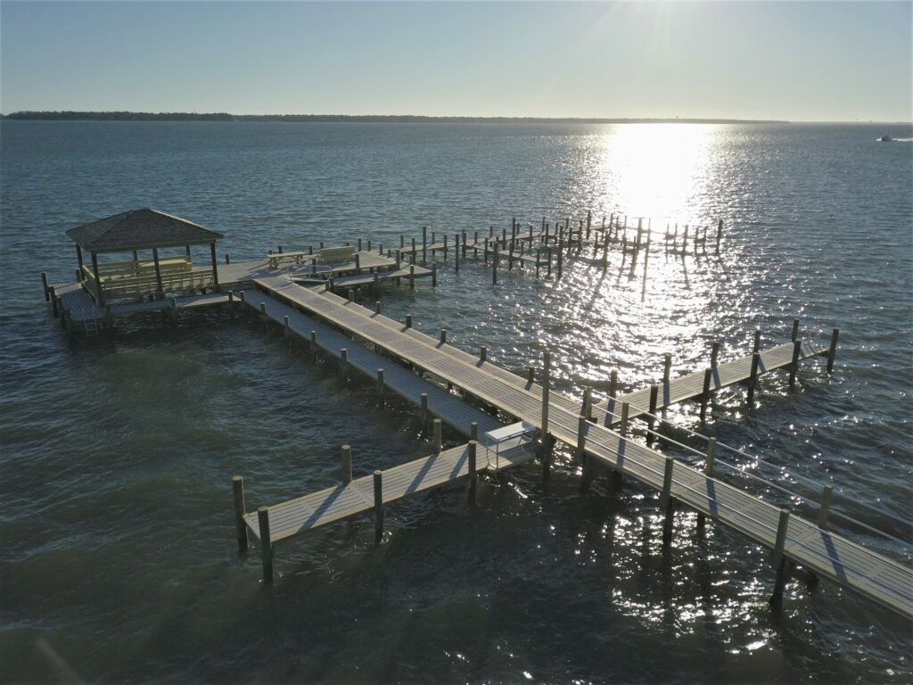 drone view of completed dock and boat slips, ocean in background. Bobby Cahoon Marine Construction