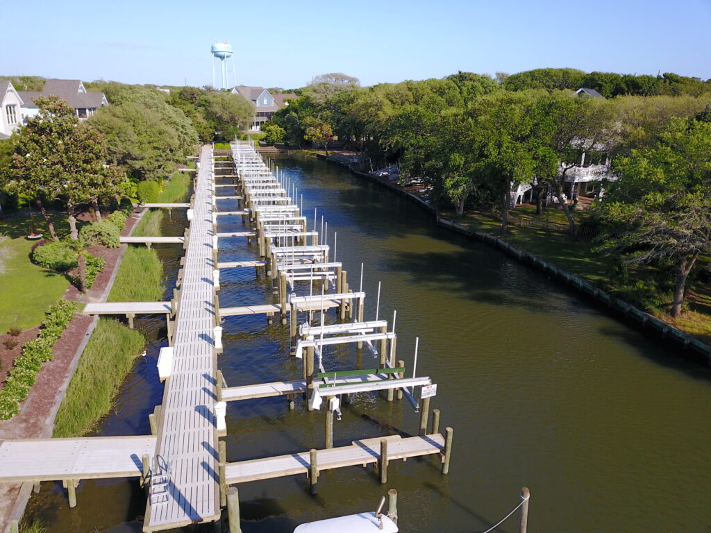 drone view of large concrete dock with multiple boat lifts, Bobby Cahoon Marine Construction
