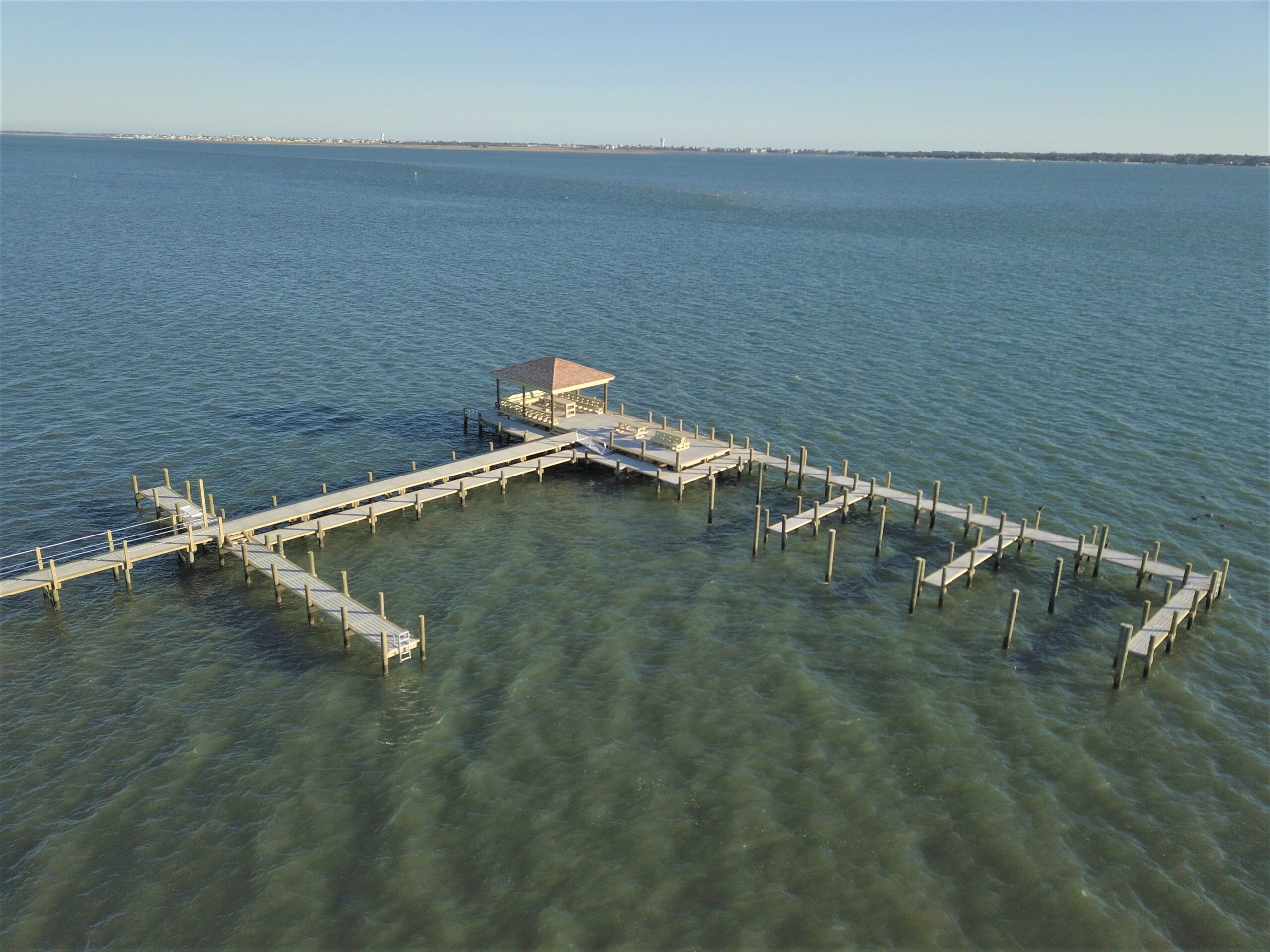 The Bluffs concrete pier in Morehead City, Eastern North Carolina, with platform, benches, sitting areas, stairs, crab dock, ramp, finger pier, and cocktail table, built by Bobby Cahoon Marine Construction, the best marine contractor in Eastern North Carolina